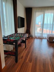 a room with a foosball table in the middle of a room at Apartment Sunny in Casa Del Mare in Varna City