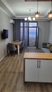 uma sala de estar com uma mesa e um sofá em Sea View House em Sumqayıt