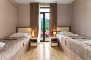 Postel nebo postele na pokoji v ubytování Panorama Ushba