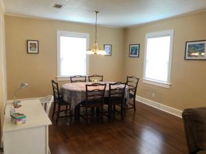 a dining room with a table and chairs at Calypso Pensacola in East Hill Neighborhood ! in Pensacola