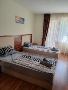 two beds sitting next to each other in a bedroom at Apartment Sunny in Casa Del Mare in Varna City