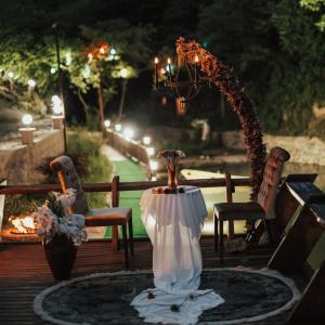 een vaas op een tafel met twee stoelen op een terras bij greenparadisehouses in Fatsa