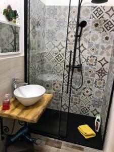 a bathroom with a sink and a shower at Il melograno in Usini +9 photos