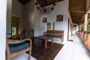 a living room with a table and chairs and a chandelier at Galeria e Suites Canto do Sol in Barra Grande