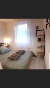 um quarto com uma cama grande e uma janela em T2 avec balcon plein sud em Lourdes