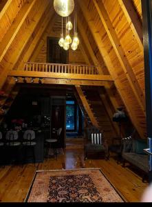 a living room with a wooden ceiling with a chandelier at greenparadisehouses in Fatsa