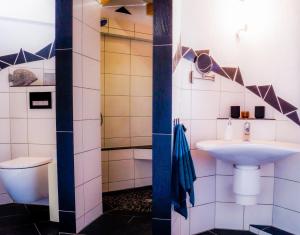 a bathroom with a sink and a toilet at Besondere Ferienwohnung Spirit auf idyllischem Reiterhof nahe Burg Eltz in Münstermaifeld +24 photos