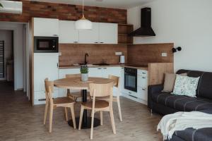 a kitchen and living room with a table and a couch at Apartmány Skoronice in Skoronice