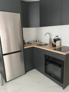 a kitchen with a stainless steel refrigerator and a sink at Mimi&Nina in Prović
