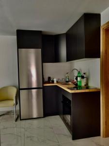 a kitchen with a stainless steel refrigerator in it at Mimi&Nina in Prović +12 photos