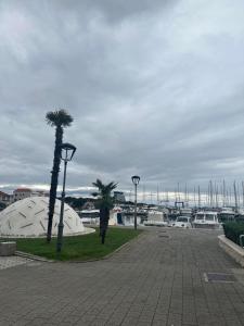 a park with palm trees and a marina with boats at Mimi&Nina in Prović