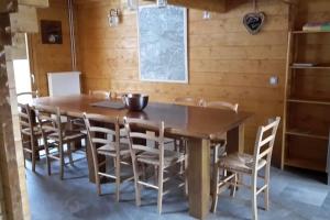 a dining room with a wooden table and chairs at Chalet le Brame en Cevennes in Camprieu +13 photos