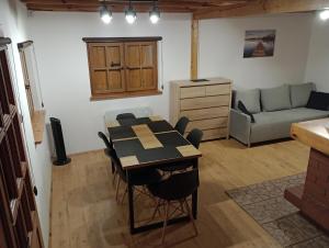 a living room with a table and a couch at Domek letniskowy U Cisków in Mściszewice
