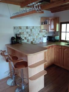 a kitchen with a wooden island in a room at Domek letniskowy U Cisków in Mściszewice +15 photos