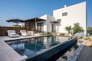 a swimming pool in front of a house at Campo Premium Stay Private Pool Villas in Kos