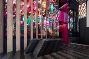 a lobby with a stained glass window and stairs at W Melbourne in Melbourne