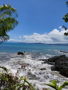 a view of the ocean from a rocky beach at Pez Espada Tours y Cabinas in Drake