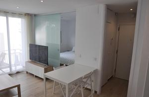 a room with a table and a mirror and a bed at Centro Sitges in Sitges