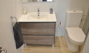 a bathroom with a sink and a toilet at Centro Sitges in Sitges +29 photos