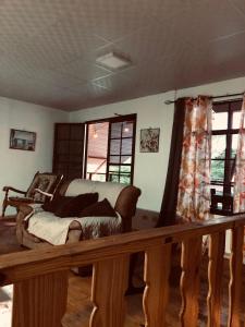 a bedroom with a bed in a room with windows at Hostal Dilu Boquete in Bajo Boquete