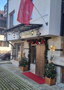 a building with christmas decorations in front of a door at Snow Pearl Residence & FREE SPA in Bansko