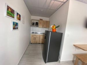 a kitchen with a stainless steel refrigerator in a room at Apartamento cerca al parque in Jardin