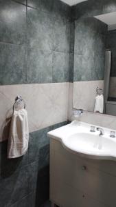 a bathroom with a sink and a mirror at Hotel Valle Del Sol in Merlo