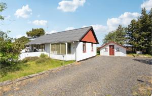 a white house with a red door on a road at 2 Bedroom Lovely Home In Rm in Kongsmark