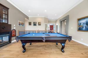 a pool table in a living room with a fireplace at Upstairs Suite in Nanaimo Spacious 3-Bed Hideaway in Nanaimo