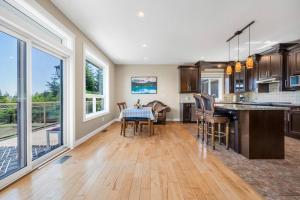 a kitchen with a table and chairs and a dining room at Upstairs Suite in Nanaimo Spacious 3-Bed Hideaway in Nanaimo