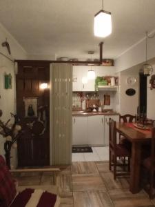 a kitchen with a table and a dining room at Dulce hogar in Santiago