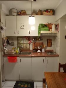 a kitchen with white cabinets and a sink at Dulce hogar in Santiago