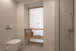 a bathroom with a toilet and a window at Lindas Convent Garden Home 1 in Chania Town +51 photos