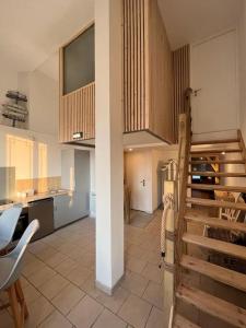 a large kitchen with a staircase in a room at Ma cabane à la plage de Dunkerque, Duplex bord de mer accès direct plage en rdc, Malo les Bains in Dunkerque