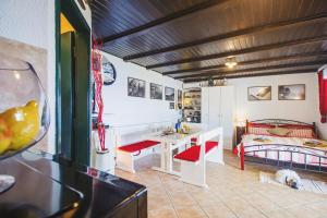 a room with a desk and a bed and a table at Holiday home Oaza in Baška Voda