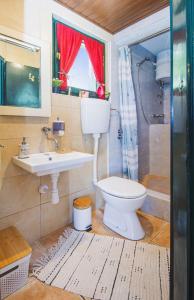 a bathroom with a toilet and a sink at Holiday home Oaza in Baška Voda