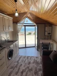 a kitchen and living room with a view of the ocean at Anatolia SUITE APART in Bostancı