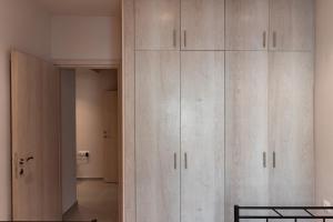 a large white cabinet in a room with a toilet at Anastasia's Apartments Halkidiki in Nea Plagia