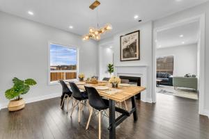 a dining room and living room with a table and chairs at Oshawa Family Haven - Luxury 7BR Villa with Cozy Fireplaces & Hot Tub in Oshawa