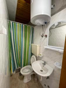 a small bathroom with a toilet and a sink at Summer Sky in Ulcinj