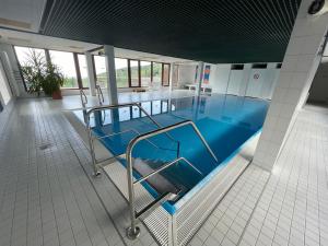 a swimming pool with a blue floor in a building at Ferienwohnung Talblick in Sasbachwalden