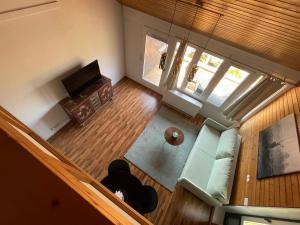 an overhead view of a living room with a couch and a television at Ferienwohnung Talblick in Sasbachwalden