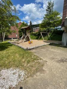 um parque infantil com um baloiço num quintal em Ferienwohnung Talblick em Sasbachwalden