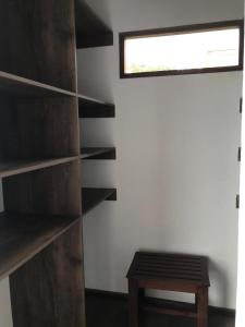 a room with wooden shelves and a bench and a window at Despierte con la naturaleza in Cogua
