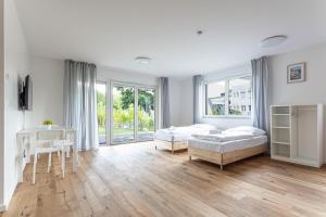 a bedroom with two beds and a table and a desk at T&K Apartments - Bergisch Gladbach - 3 Comfortable Apartments - 18 min to Fair Messe Cologne in Bergisch Gladbach