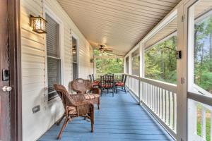 a porch with wicker chairs and tables on it at Pet Friendly Group Getaway with Grill and Deck in Acworth