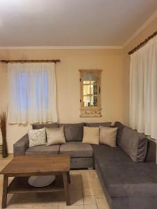 a living room with a couch and a coffee table at Villa Ioanna in Kalamitsi