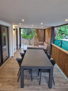 a dining room with a table and chairs at Mobile home Sofija in Drage