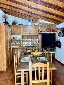 una cocina con mesa de madera y sillas y una cocina con en Villa de Taburiente en El Paso