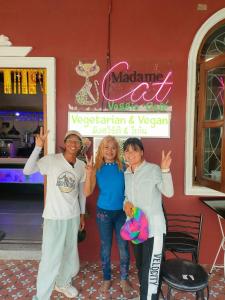 a group of people standing in front of a restaurant at Cat Home in Hat Yai
